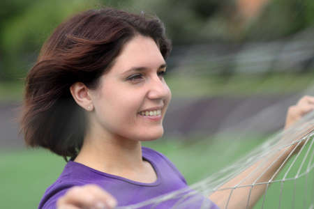 Beautiful Fitness Woman Behind Sports Netの写真素材