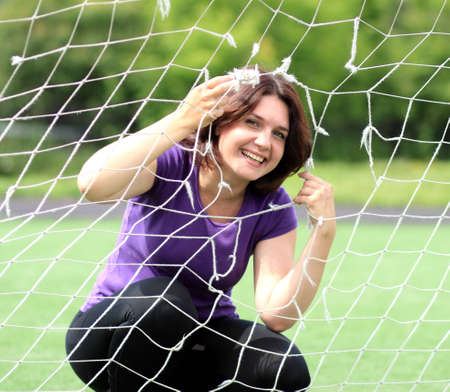 Beautiful Fitness Woman Behind Sports Netの写真素材