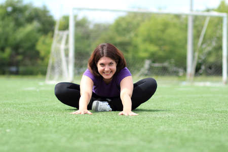 Beautiful Fitness Woman Sitting at Stadiumの写真素材