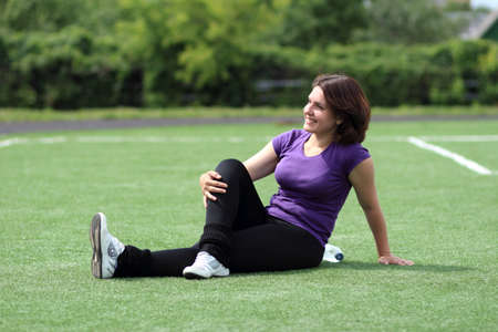 Beautiful Fitness Woman Sitting at Stadiumの写真素材
