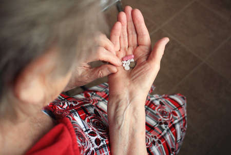 Drugs in old woman's handsの写真素材