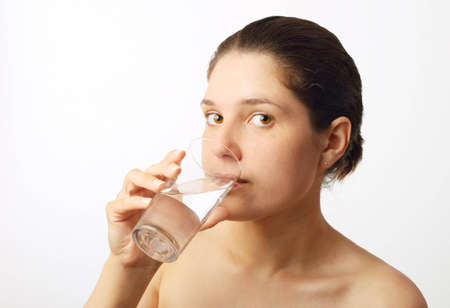 Young beautiful woman drinking waterの写真素材