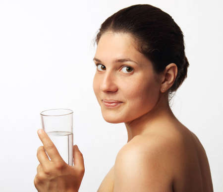 Young beautiful woman drinking waterの写真素材