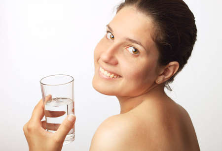 Young beautiful woman drinking waterの写真素材