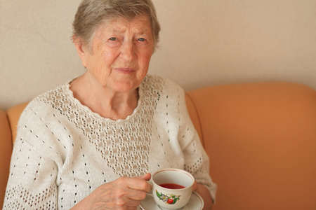 Elderly woman with cup of teaの写真素材