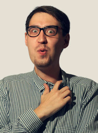 Surprised funny young man wearing glassesの写真素材