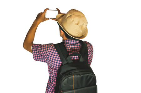 Back view of traveler man taking photo with smart phone isolate on white backgroundの写真素材