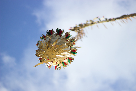 Balinese penjor is a symbol of galungan holiday on a blue skyの写真素材