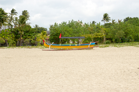 Balinese fishing boat on sand at Kuta beach.の写真素材