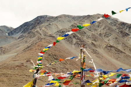Tibetan colored flags with the background of mountains in India