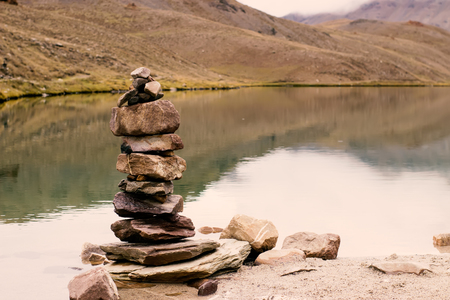 Stone balance with the background of a high mountain lake in Himalayaの写真素材