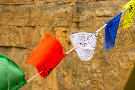 Buddhist colored flags with mantras about peace, good, happiness. Faith in a bright futureの写真素材