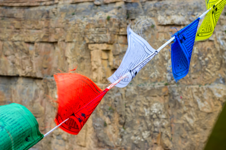 Buddhist colored flags with mantras about peace, love, happiness. Faith in a bright futureの写真素材