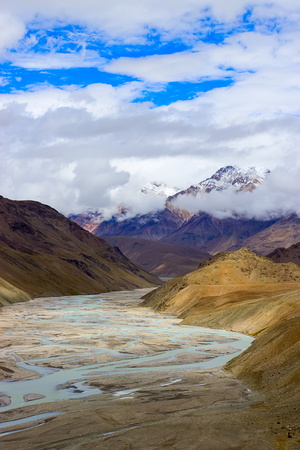 River between the mountains and clouds with blue sky. Trekking concept.の写真素材