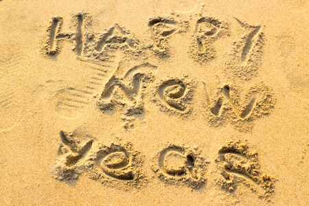 Inscription Happy New Year on the sand. Christmas conceptの写真素材