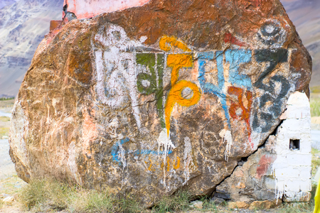 Inscription from Tibetan symbols on a stone in the mountainsの写真素材