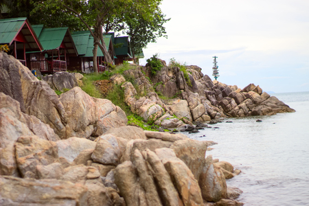 Bungalows standing on a rocky shore by the sea. Travel and relax concept.の写真素材