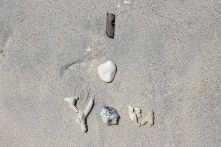 I love you written in corals, shells and sticks on the sand as a message of love for your soul mate. Romantic concept. Post card.の写真素材