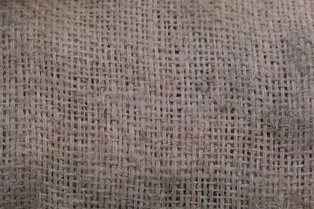 The texture of the brown canvas bag. A piece of a bag for building materials close-up.の写真素材