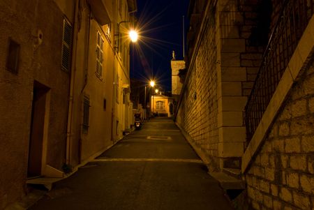 Night shot of an alley with stone walls in Cannesの写真素材