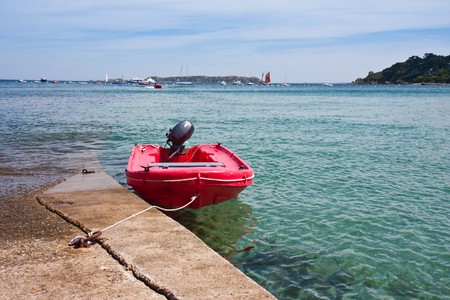 Mored small boat at pier by high tide in Bretagne, Franceの写真素材