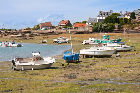 Ships by ebb-tide in small harbor of Ploumanach, Brittany, Franceの写真素材