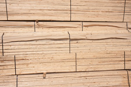 Pile of wooden planks waiting for transport to the factoryの写真素材