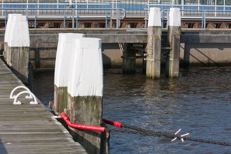 Jetty with big wooden bollards in a Dutch harborの写真素材