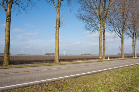 Peaceful rural Dutch landscape with windturbinesの写真素材