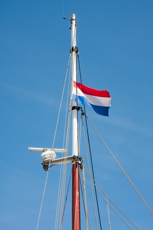 Dutch flag in top of a saling vesselの写真素材