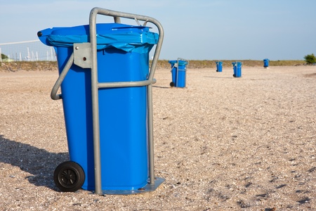Big blue dust bins at the beachの写真素材