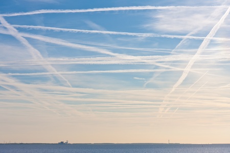 aerodynamic trails from plains above the Dutch seaの写真素材