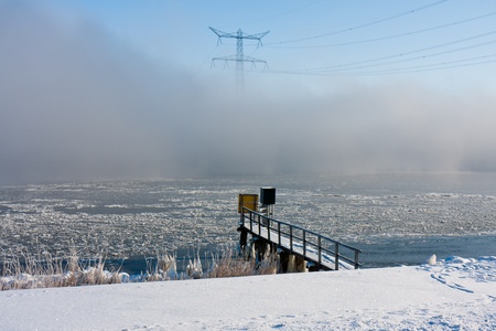 Winter haze above a frozen lake in the Netherlandsの写真素材