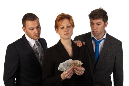 Business woman is counting money with her colleagues looking; isolated on white