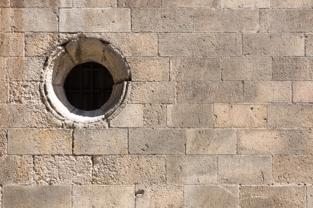 Old brick wall with circular windowの写真素材
