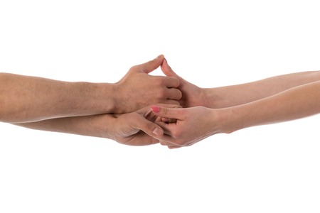 Four hands holding each other isolated over whiteの写真素材