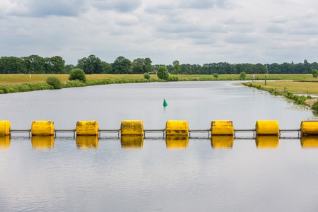 Floating yellow barrage in Dutch river Vechtの写真素材