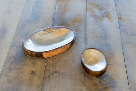 Wooden table with ashtrays from seashellsの写真素材