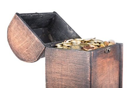Wooden money chest filled with coins isolated at a white background, isolated over whiteの写真素材