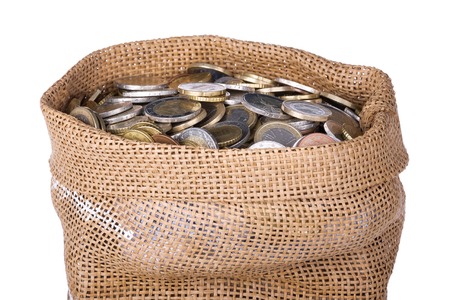 Money bag with coins isolated at a white background, isolated over whiteの写真素材
