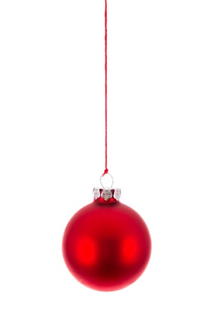 Red Christmas ball hanging at a red rope over whiteの写真素材