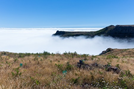 Aerial view form top of Madeira mountains with a cloud cover over the Atlantic Oceanの写真素材