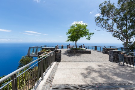FUNCHAL, PORTUGAL - AUG 04: Tourists visiting Gabo Girao, a viewpoint at a cliff 600 meters above the sealevel on August 04, 2014 near Funchal, Madeira Island Portugalのeditorial素材