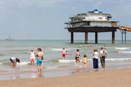 SCHEVENINGEN THE NETHERLANDS JUN 05: Seaside visitors relaxing near the Pier of Scheveningen at the first hot summerday on 5 June 2015 at the beach of Scheveningen the Netherlandsのeditorial素材
