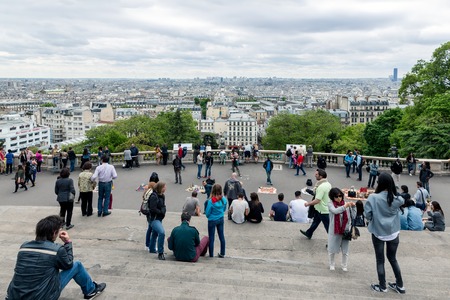 PARIS FRANCE May 28: Tourists admiring the skyline of Paris from the stairs of the Sacre Coeur Basilica the highest point city of Paris on May 28 2015 Paris Franceのeditorial素材
