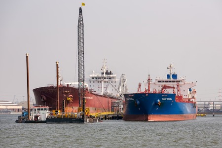 ANTWERP, BELGIUM - AUG 13: Harbor of Antwerp with moored big cargo ships on August 13, 2015 in the harbor of Antwerp, Belgiumのeditorial素材