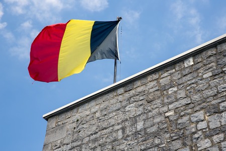 Belgian flag in top of citadel Dinant in Belgiumの写真素材