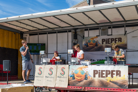 EMMELOORD, THE NETHERLANDS - SEP 10: Competition of kids peeling potatoes at an agricultural potato festival on September 10, 2016 in Emmeloord, capitial city of Noordoostpolder, the Netherlandsのeditorial素材