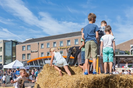 EMMELOORD, THE NETHERLANDS - SEP 10: Kids playing at hay bales on an agricultural potato festival on September 10, 2016 in Emmeloord, capitial city of Noordoostpolder, the Netherlandsのeditorial素材
