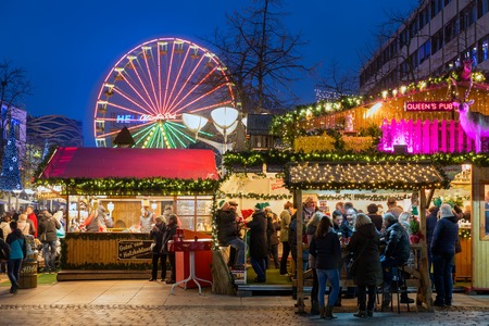 DUISBURG, GERMANY - DECEMBER 17, 2016: Unknown people at traditional christmas market with illuminated ferris wheel in the center of Duisburg, Germanyのeditorial素材